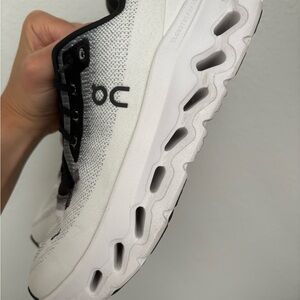 On Running White and Black Athletic Shoes